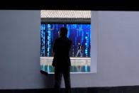 A man walks in front of a screen at the World Internet Conference (WIC) in Wuzhen