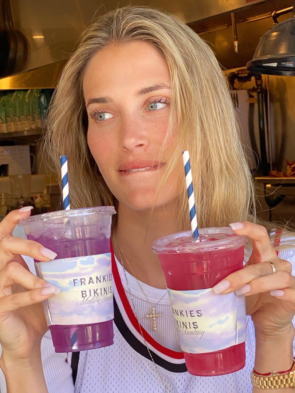 Frankies Bikinis Founder and Creative Director Francesca Aiello holding up the limited-edition Bluestone lemonades that were inspired by the brand. The drinks are named “Frankies Fantasy” and “Sunset Spritzer.” - Credit: Courtesy Photo