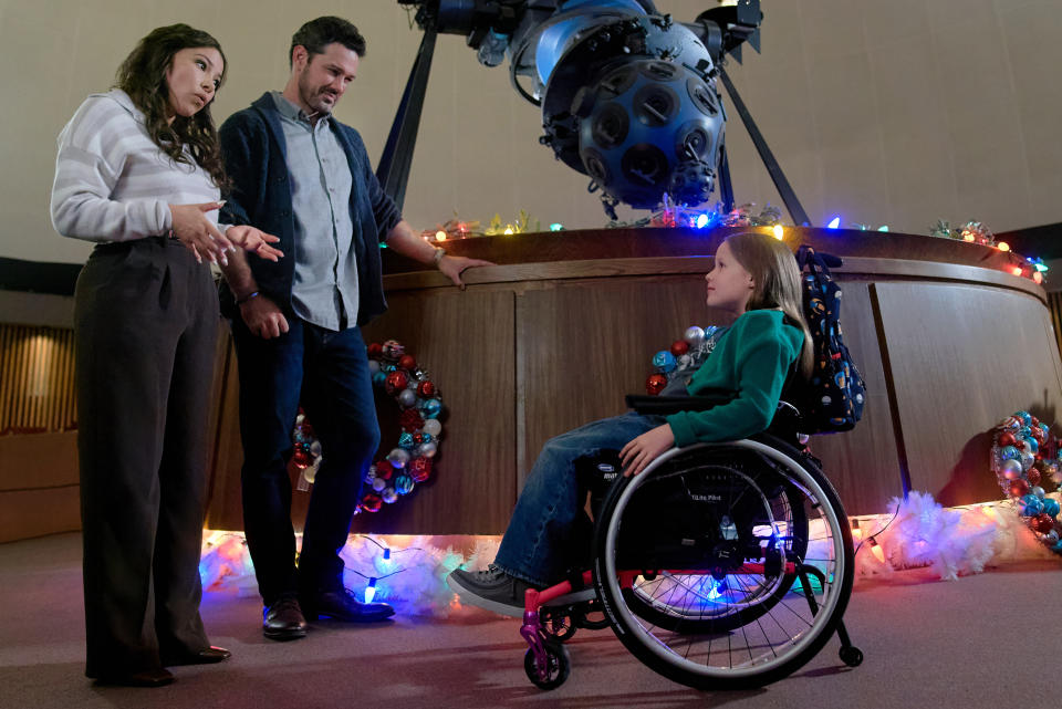 Jessica Parker Kennedy, Ryan Paevey and Emmy Richardson in Under the Christmas Sky. (2023 Hallmark Media/Steven Ackerman)