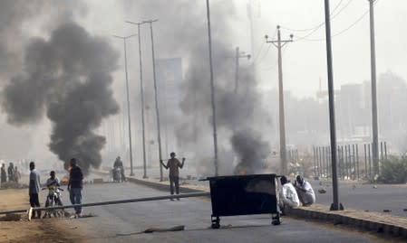 Sudanese protesters erect a barricade on a street and demanding that the country's Transitional Military Council hand over power to civilians in Khartoum