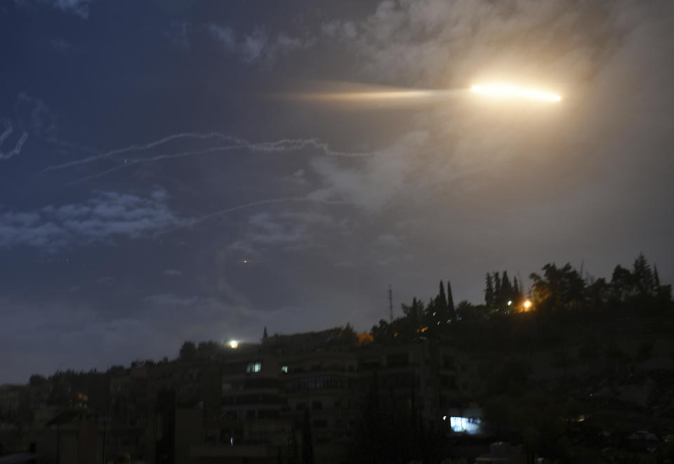 In this photo released by the Syrian official news agency SANA, shows missiles flying into the sky near international airport, in Damascus, Syria, Monday, Jan. 21, 2019. In a very unusual move, the Israeli military has issued a statement saying it is attacking Iranian military targets in Syria. It is also warning Syrian authorities not to retaliate against Israel. (SANA via AP)