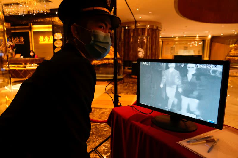 A security guard monitors thermal scanners that detect temperatures of visitors at the closed Grand Lisboa casino and hotel, following the coronavirus outbreak in Macau