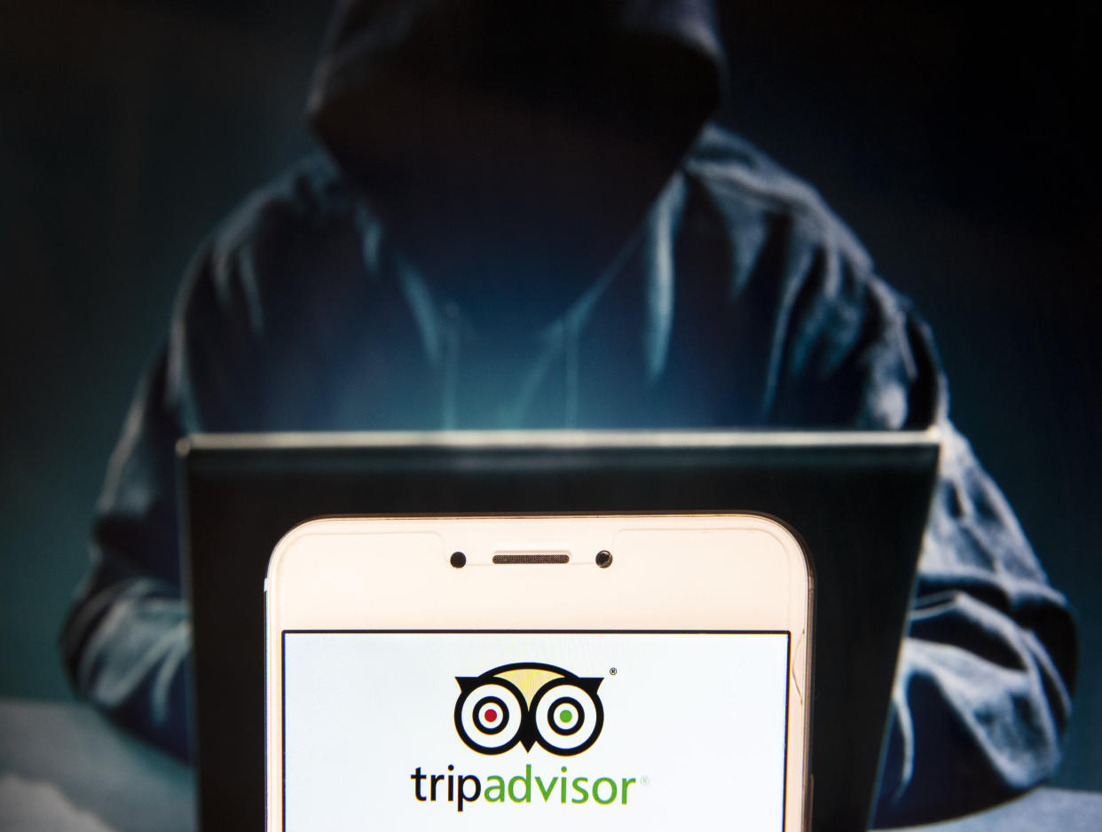 HONG KONG, CHINA - 2018/12/02:  In this photo illustration, the American travel agency and restaurant website company TripAdvisor logo is seen displayed on an Android mobile device with a figure of hacker in the background. (Photo Illustration by Miguel Candela/SOPA Images/LightRocket via Getty Images)