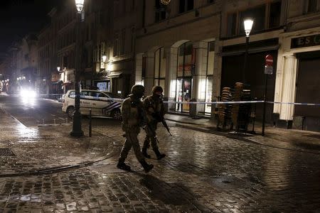 Belgian soldiers patrol a along a street during a high level of security situation following the recent deadly Paris attacks, in Brussels, Belgium, November 22, 2015. REUTERS/Youssef Boudlal