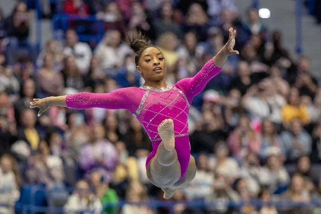 <p>Tim Clayton/Corbis via Getty Images</p> Simone Biles performs her floor routine during the 2024 Core Hydration Gymnastics Classic at the XL Centre, Hartford on May 18, 2024