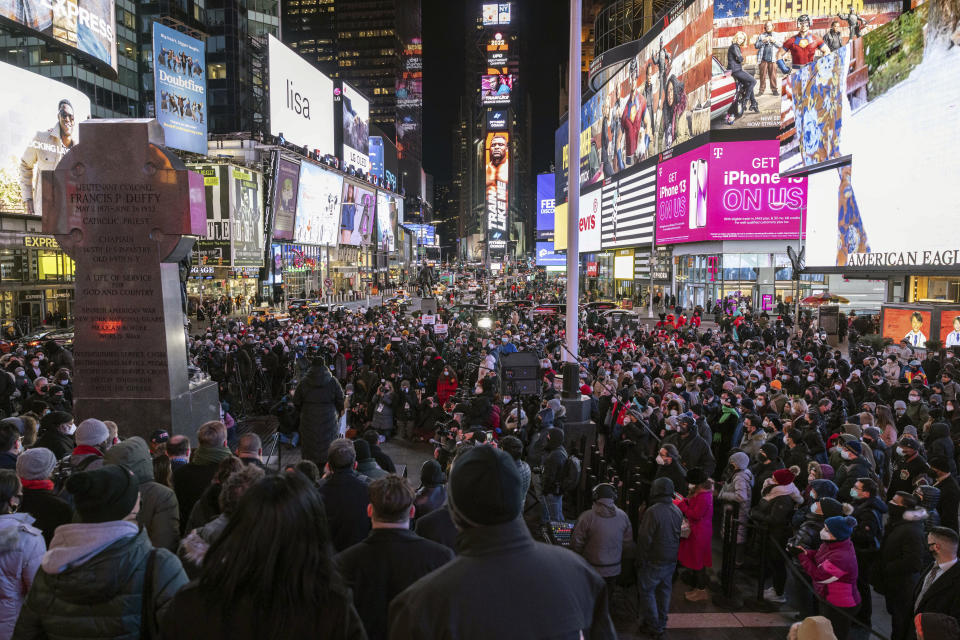 People gather for a candlelight vigil in honor of Michelle Alyssa Go, a victim of a recent subway attack, at Times Square on Tuesday, Jan. 18, 2022, in New York. (AP Photo/Yuki Iwamura)