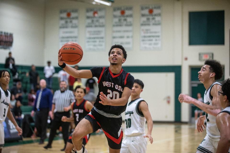 West Oso's Brandon Simmons attempts a basket during the game Tuesday, Nov. 30, 2021, at King High School.