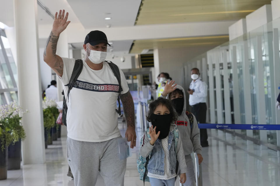 The first group of tourists arrive on an Etihad flight from Abu Dhabi at the Phuket International Airport in Phuket, Thailand, Thursday, July 1, 2021. Starting Thursday, Thailand is welcoming back international visitors — as long as they are vaccinated — to its famous southern resort island of Phuket without having to be cooped up in a hotel room for a 14-day quarantine. (AP Photo/Sakchai Lalit)