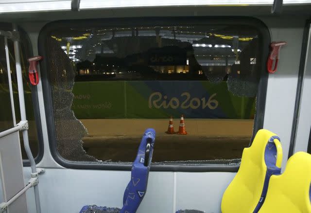 The window on an Olympic media bus after it shattered when driving journalists. (Reuters)