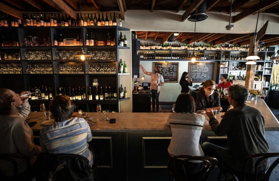 People sit at a wine bar.