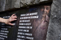 Mary Elledge, head of the greater Portland chapter of Parents of Murdered Children, looks at the name of her son, Rob, on a memorial in Oregon City, Ore., Wednesday, July 20, 2022. Elledge, whose son was murdered in 1986 and the case unresolved for months, is opposed to resources being taken from cold case units to address rising homicides. "The unsolved cases are where I see so much sadness," Elledge said of the families she works with. "When they don’t get an answer, it’s like nobody cares and they never find out what happened." (AP Photo/Craig Mitchelldyer)