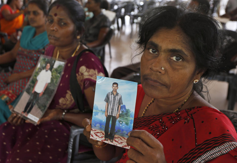 FILE - In this Nov. 14, 2013, file photo, Sri Lankan ethnic Tamils hold portraits of family members who have disappeared at a gathering organized by the main opposition United National Party (UNP) in Colombo, Sri Lanka. Worries about Islamic extremism will be paramount for many Sri Lankan voters while others hope to block former leaders accused of human rights violations from returning to power in Saturday’s presidential election, the country’s first national polls since last Easter’s deadly suicide attacks. (AP Photo/Eranga Jayawardena, File)