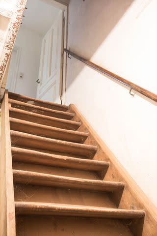 <p>Getty</p> Stock image of basement stairs.