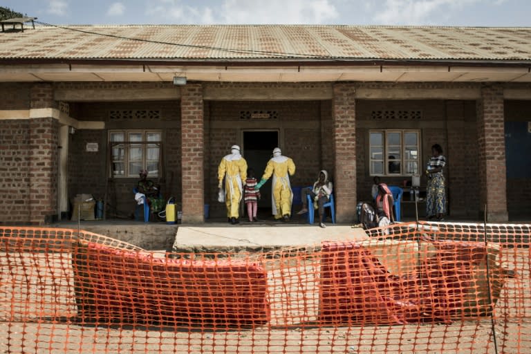 Medical workers lead a young girl with suspected Ebola into the unconfirmed Ebola patients ward run by The Alliance for International Medical Action (ALIMA) in Beni, northeastern DRC