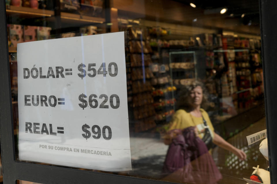 A shop displays on a sheet of paper unofficial currency exchange rates in Buenos Aires, Argentina, Wednesday, April 26, 2023. (AP Photo/Natacha Pisarenko)