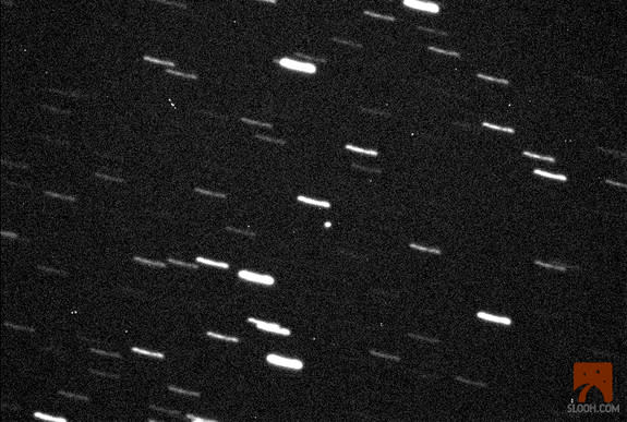 The 460-foot (140-meter) asteroid 2013 ET is seen through a Slooh Space Camera telescope in the Canary Islands on March 9, 2013, during its close approach to Earth. The asteroid was just within 600,000 miles of Earth, about 2.5 times the Earth-