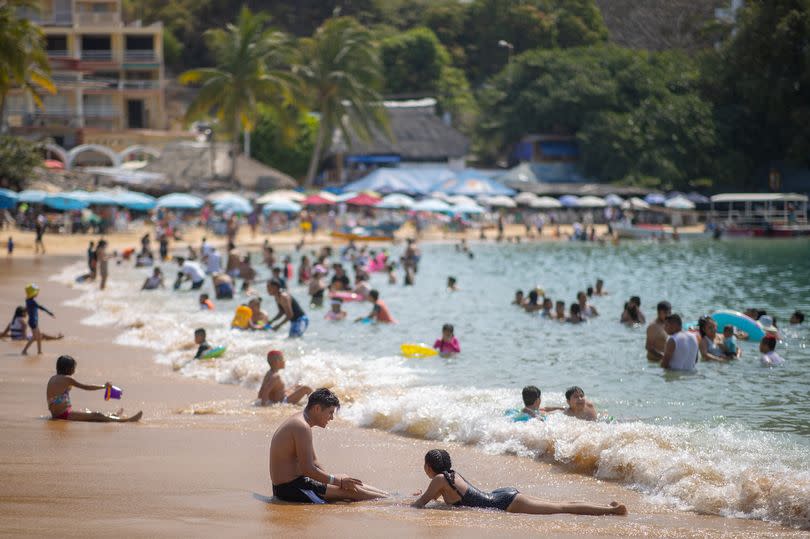 People on Caleta beach in Acapulco, Mexico