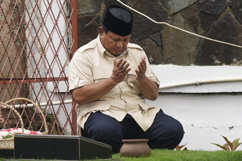 Indonesian Defense Minister and presidential frontrunner Prabowo Subianto prays at his father's grave in Jakarta, Indonesia Thursday, Feb. 15, 2024. The wealthy ex-general looks set to be the country's next president after unofficial tallies showed him taking a clear majority in the first round of voting. (AP Photo/Tatan Syuflana)