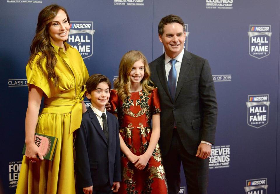 Former NASCAR driver Jeff Gordon, right, smiles for photographers with his wife, Ingrid Vandebosch, left and children, Leo and Ella Sofia, center at the NASCAR Hall of Fame on Friday, February 1, 2019. Gordon is being inducted into the Hall of Fame Friday evening.