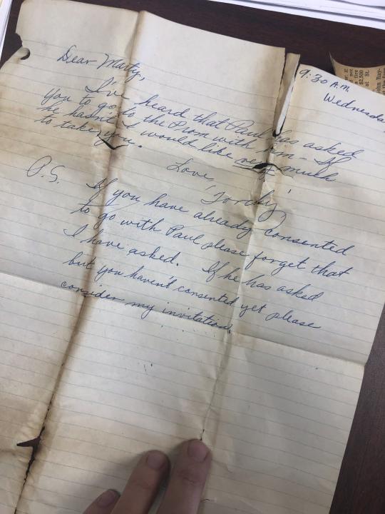 This undated photo provided by Greater Clark County Schools in Jeffersonville, Ind., shows a letter requesting a date to prom found inside of a purse of a student who attended the school in the mid 1950s. The purse was recently discovered when a construction crew demolished part of the old Jeffersonville High School building. The purse, which contained a prom invitation, photos and other items from 1950s America, will be returned to its now 82-year-old owner after workers found it while demolishing part of an Indiana high school. (Greater Clark County Schools via AP)