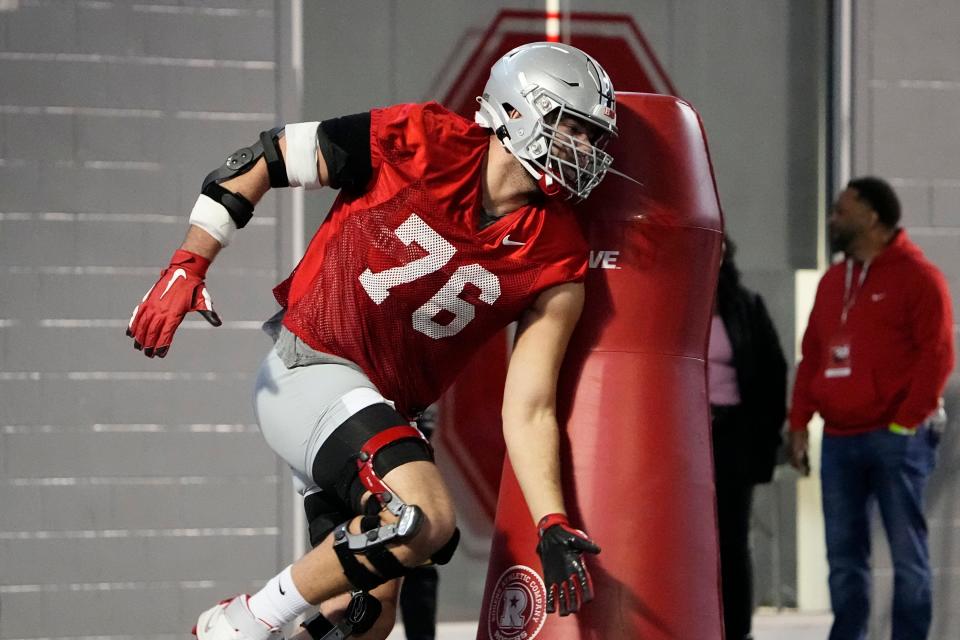 Mar 9, 2023; Columbus, Ohio, USA;  Ohio State Buckeyes offensive lineman Miles Walker hits a tackling dummy during spring football practice at the Woody Hayes Athletic Center. Mandatory Credit: Adam Cairns-The Columbus Dispatch