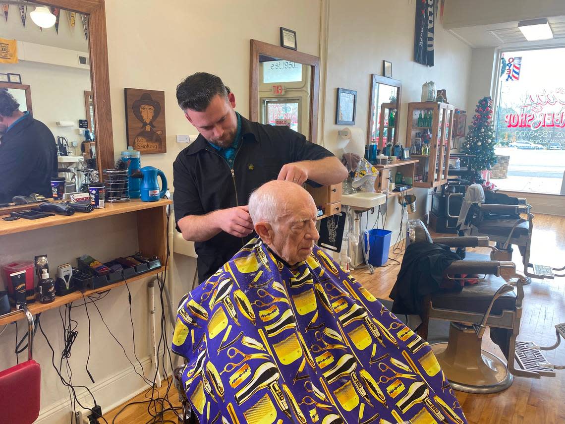 Nick Arnold, manager of City Barber Shop in Carthage, NC, cuts hair once power was restored in his section of Moore County.