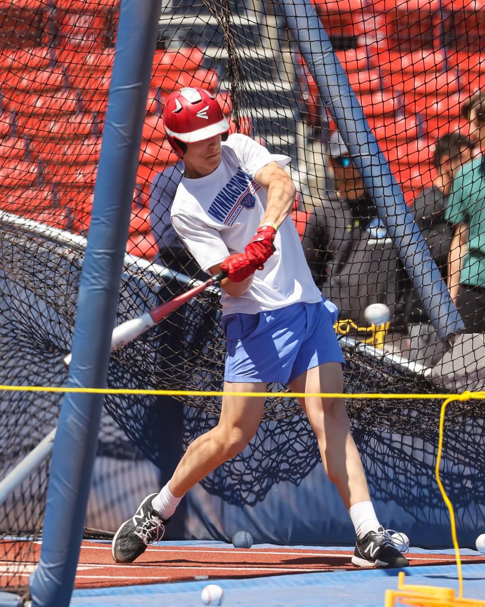 Winnacunnet's Cash O'Hara takes a swing during a private 30-minute team batting practice session Friday at Fenway Park.  O'Hara was the first Warrior to put a ball off the Green Monster.