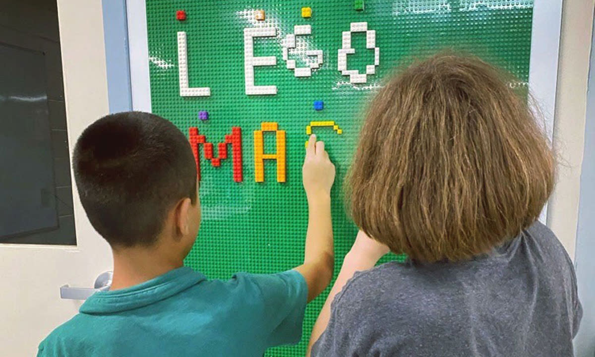 This is a photo of two elementary boys playing with Legos.