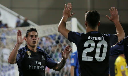 Football Soccer- Leganes v Real Madrid - Spanish La Liga Santander - Butarque Stadium, Leganes, Spain - 05/04/17 Real Madrid's James Rodriguez (L) celebrates with team mate Marco Asensio after scoring a goal. REUTERS/Sergio Perez