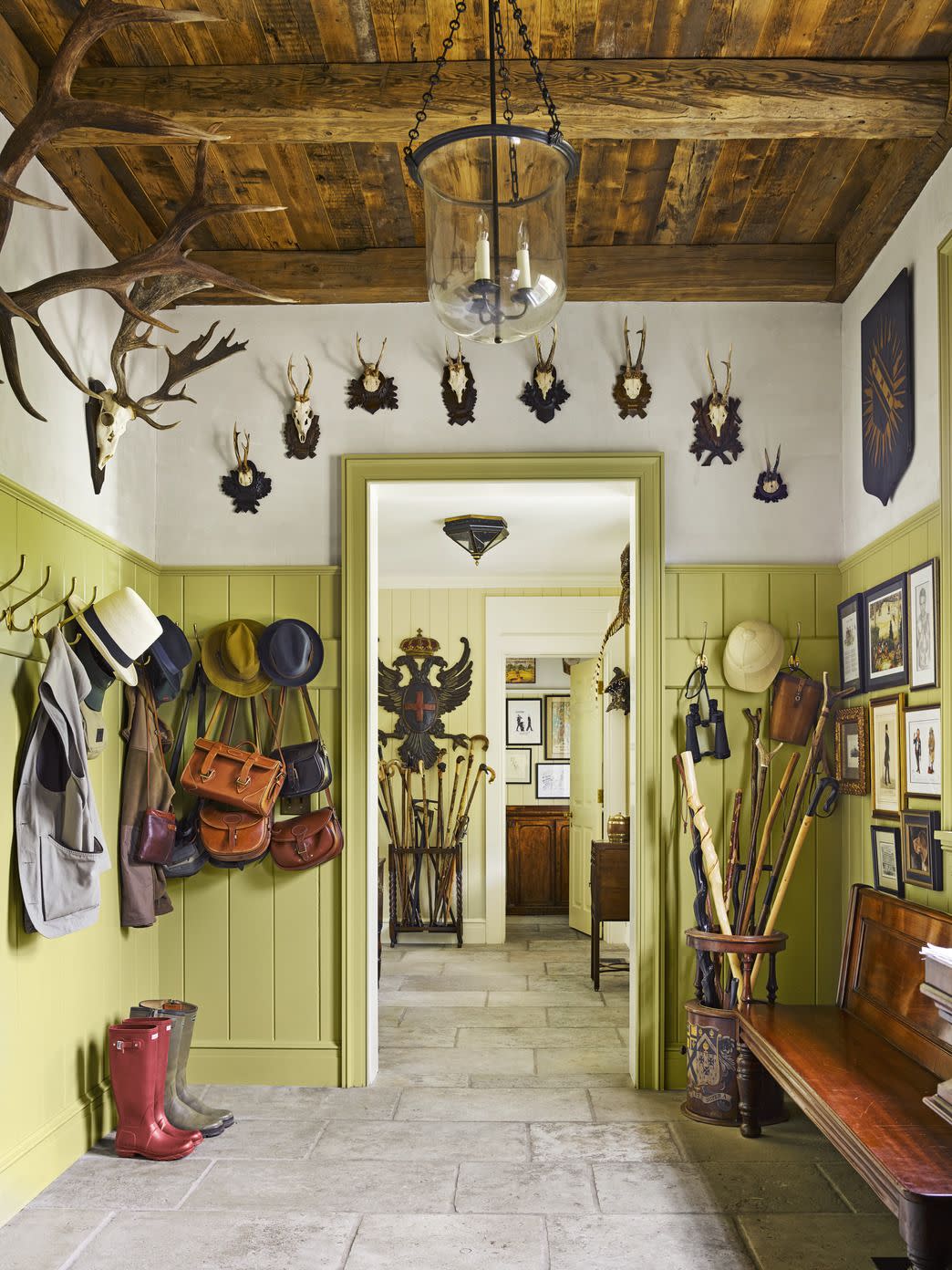 mudroom with antler mounts and an umbrella stand filled walking sticks