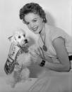 <p>Child acterss Natalie Wood had no difficulty getting her poodle, Grebel, to dress in that year's holiday seal.</p>