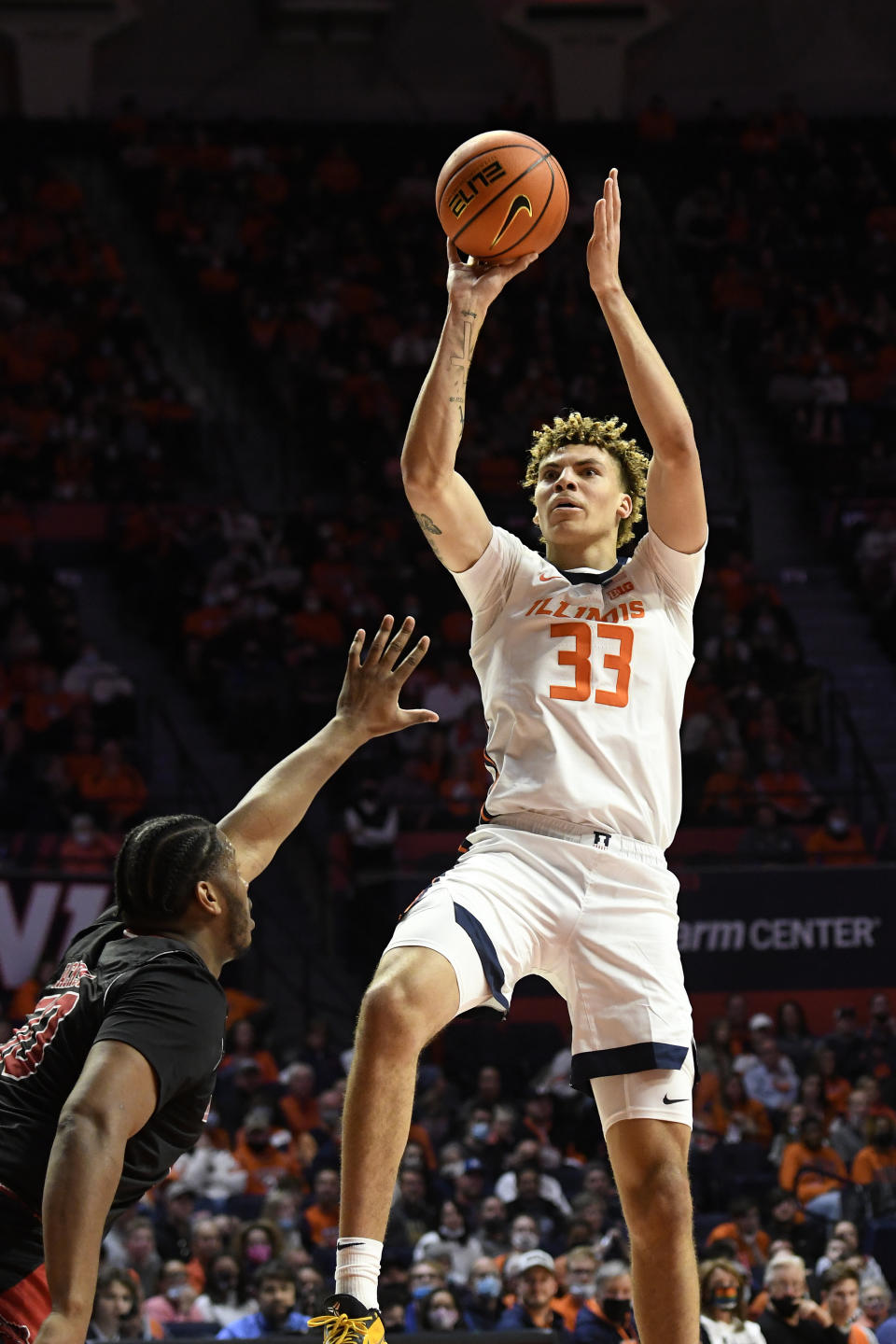 Illinois' Coleman Hawkins (33) shoots over Arkansas State's Antwon Jackson during the first half of an NCAA college basketball game Friday, Nov. 12, 2021, in Champaign, Ill. (AP Photo/Michael Allio)