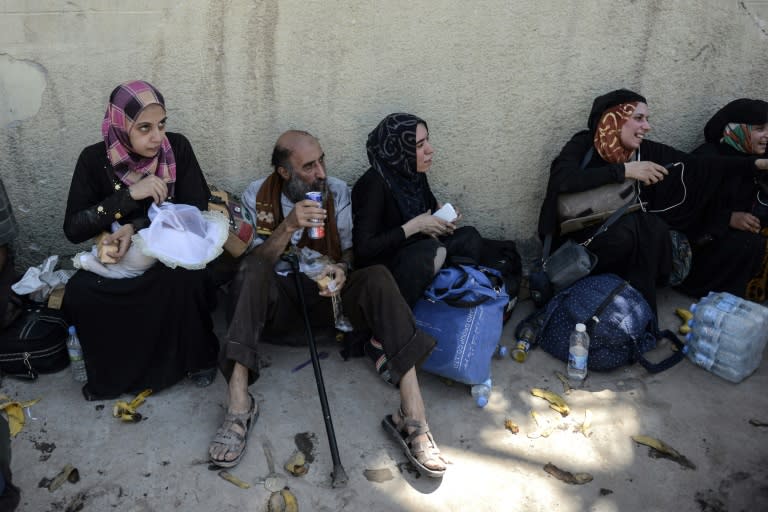 Iraqis fleeing the Old City of Mosul are seen in the industrial district of the city on June 23, 2017