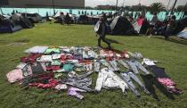 Clothing dries at the campsite of Indigenous protesters in Bogota, where thousands traveled in a caravan from Cali, Colombia, Monday, Oct. 19, 2020. The leaders of the indigenous communities say they are mobilizing to reject massacres, assassinations of social leaders, criminalization of social protest, to defend their territory, democracy and peace, and plan to stay in the capital for a nationwide protest and strike on Oct. 21. (AP Photo/Fernando Vergara)