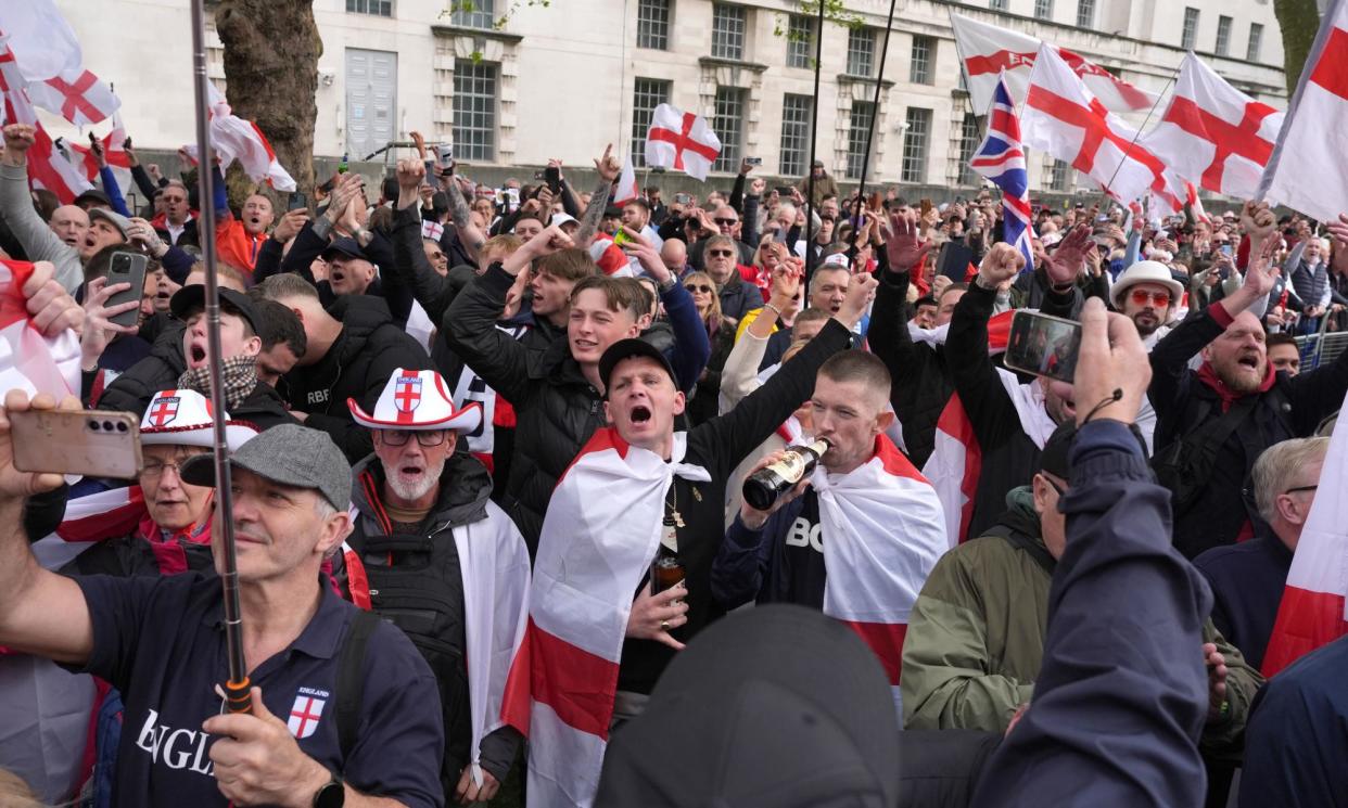 <span>People wave flags during a St George's Day rally on Whitehall, in Westminster, central London, on 23 April.</span><span>Photograph: Jordan Pettitt/PA</span>