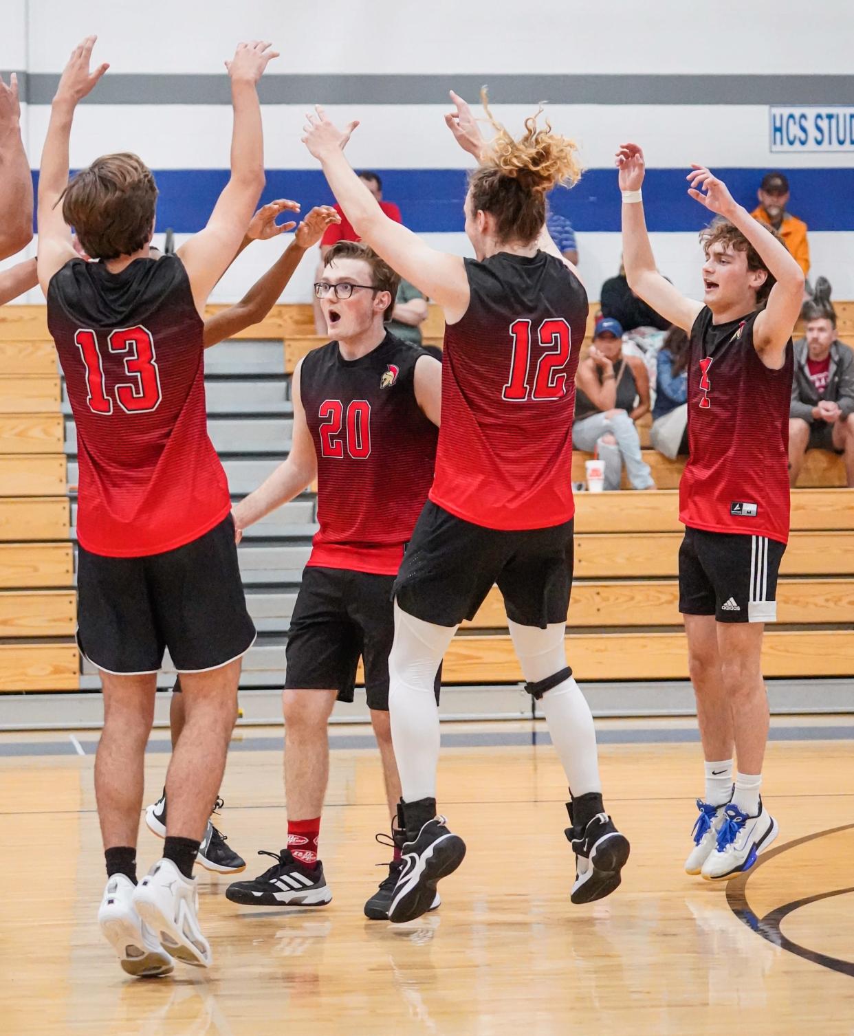 The Herron boys varsity volleyball teams celebrates a point during a game between Herron High School Achaeans and Heritage Christian High School Eagles on Tuesday, May 7, 2024, at H.C.H.S. in Indianapolis.