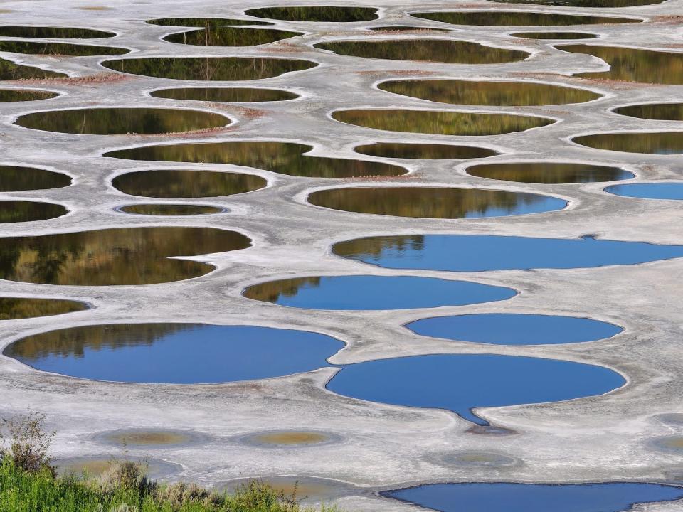 Colorful pools are seen spotting the surface of the earth at the spotted lake in Canada