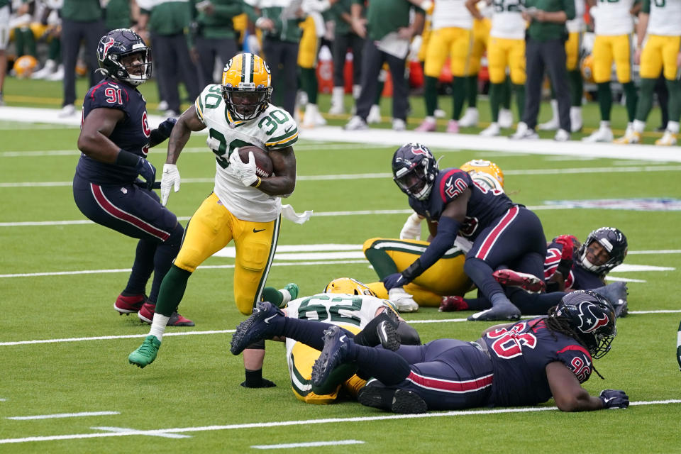 Green Bay Packers running back Jamaal Williams (30) runs with the ball during the second half of an NFL football game against the Houston Texans Sunday, Oct. 25, 2020, in Houston. (AP Photo/Sam Craft)