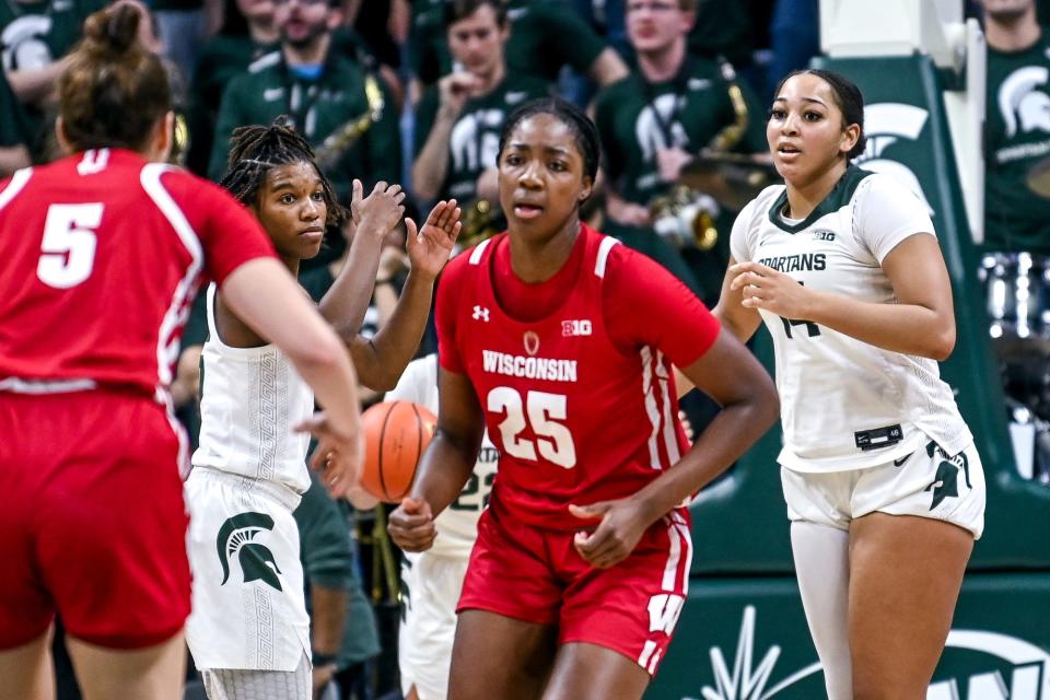 Michigan State's Kamaria McDaniel, left, and Taiyier Parks, right, react after Wisconsin's Serah Williams, center, scores late during overtime on Wednesday, Jan. 11, 2023, at the Breslin Center in Lansing.