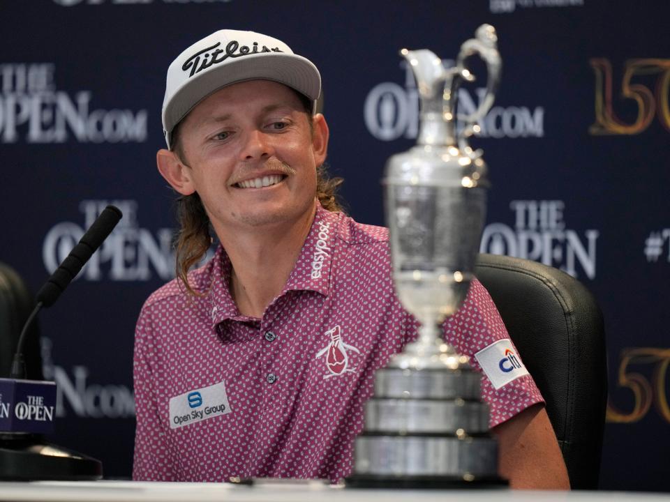 Cam Smith smiles with the Claret Jug after winning the 2022 Open Championship.