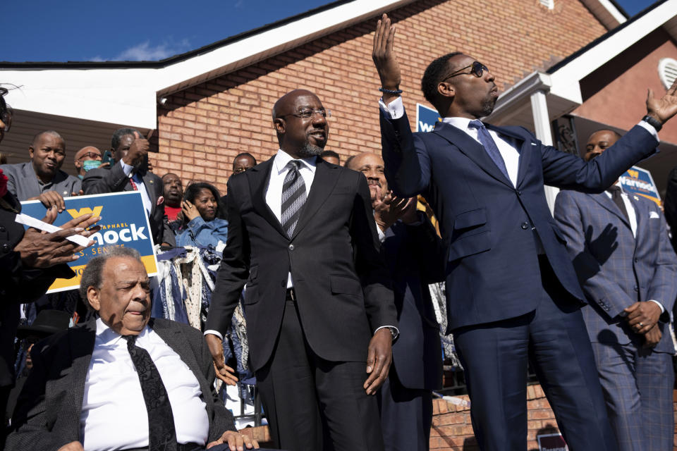 FILE - Sen. Raphael Warnock, D-Ga., center, prepares to speak at a rally after being introduced by Civil Rights icon Andrew Young, left, and Atlanta Mayor Andre Dickens on Nov. 27, 2022, in Atlanta. (AP Photo/Ben Gray, File)