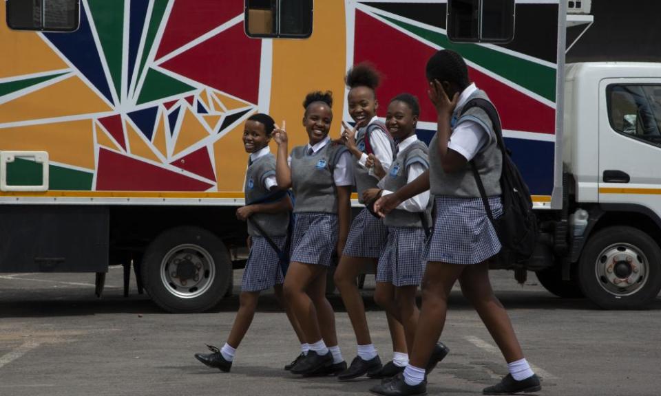 Schoolgirls pass a mobile reproductive health clinic in Soshanguve township, near Pretoria, South Africa. Such outreach projects will be irretrievably harmed by the aid cuts, experts say.