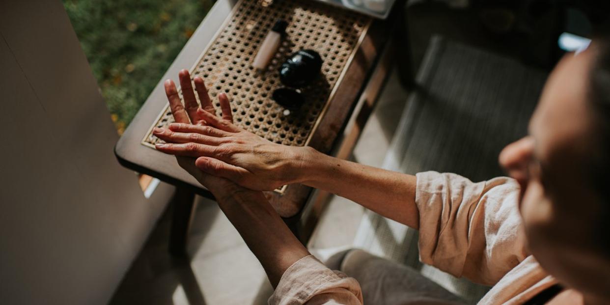 a woman moisturises her hands