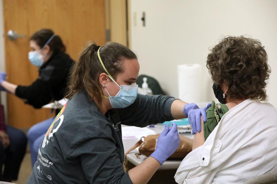 A physician at UF Health administers a dose of a Pfizer COVID-19 vaccination during a vaccination session at Mt. Moriah Missionary Baptist Church in Gainesville.
