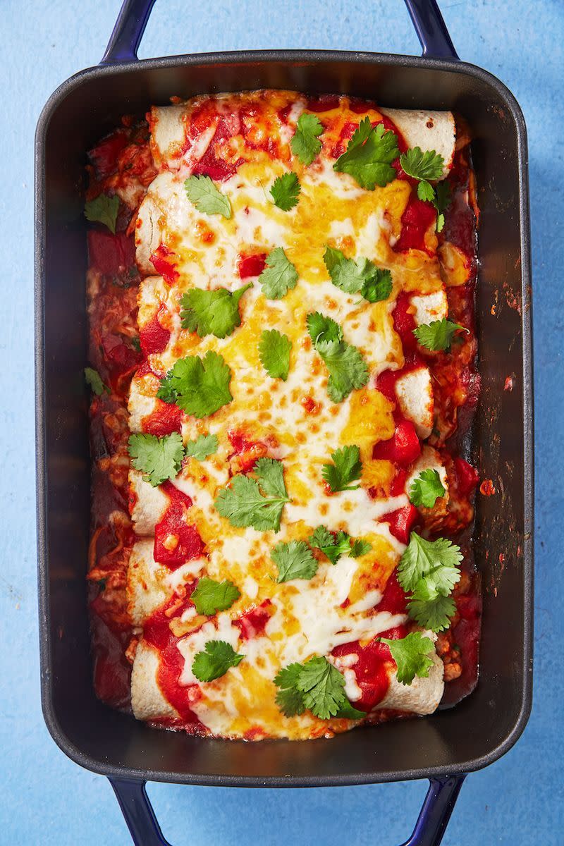 <p>These enchiladas fall somewhere in between Texan and <a href="https://www.delish.com/cooking/g1393/traditional-mexican-food-0710/" rel="nofollow noopener" target="_blank" data-ylk="slk:Mexican;elm:context_link;itc:0;sec:content-canvas" class="link ">Mexican</a>; they're definitely <a href="https://www.delish.com/cooking/g1992/tex-mex/" rel="nofollow noopener" target="_blank" data-ylk="slk:Tex-Mex;elm:context_link;itc:0;sec:content-canvas" class="link ">Tex-Mex</a> at their core, but we went with corn tortillas in place of traditional flour (you do you, though!) They may not be authentic by, well, <em>anyone's</em> standards, but they are quick, easy, filling, and delicious.</p><p>Get the <strong><a href="https://www.delish.com/cooking/recipe-ideas/a49105/cheesy-chicken-enchiladas-recipe/" rel="nofollow noopener" target="_blank" data-ylk="slk:Cheesy Chicken Enchiladas recipe;elm:context_link;itc:0;sec:content-canvas" class="link ">Cheesy Chicken Enchiladas recipe</a>.</strong></p>