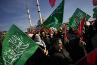 People wave Hamas flags as they march during a protest in support of Palestinians and calling for an immediate ceasefire in Gaza, in Istanbul, Turkey, Sunday, Jan. 14, 2024. (AP Photo/Emrah Gurel)