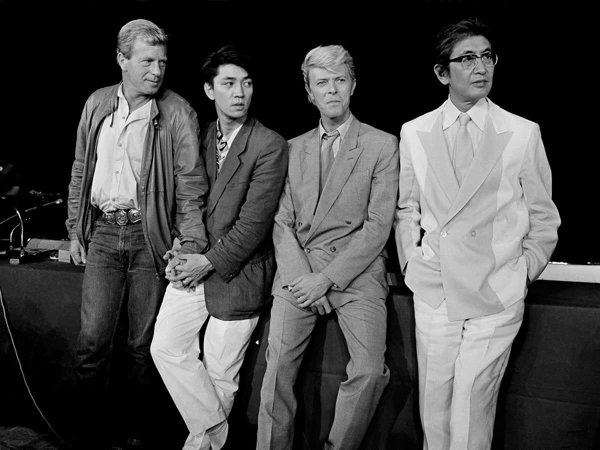 The team behind ‘Merry Christmas, Mr Lawrence’ in Paris in 1983. From left: Jack Thomas, Ryuichi Sakamoto, David Bowie, and Nagisa Oshima (AP)