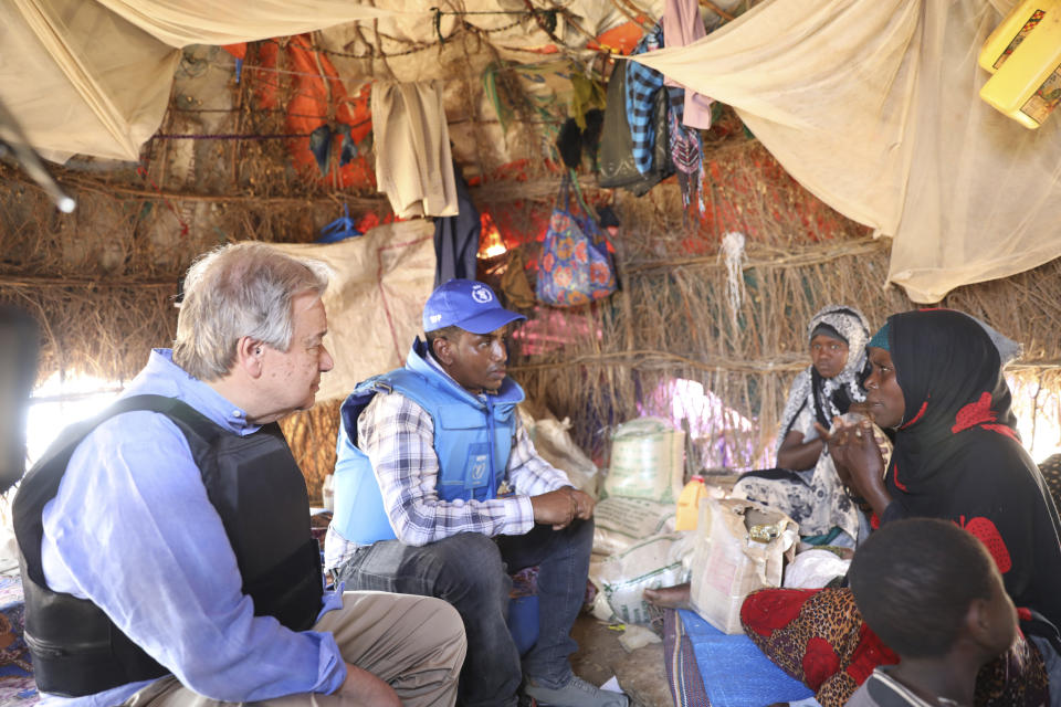 UN Sec General, Antonio Guterres, left talks to Somali family through a translator, middle, in a refugee camp in Mogadishu Tuesday April 11, 2023. U.N Secretary-General Antonio Guterres has appealed for “massive international support” for Somalia as he visited the East African country that is facing the worst drought in decades. (AP Photo)