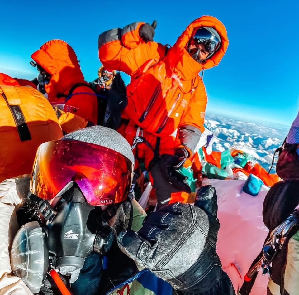 lucy at the top of everest with oxygen mask on