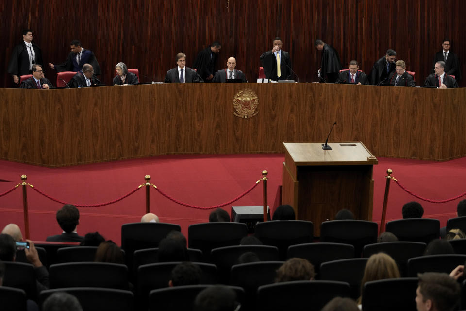 President of the Supreme Electoral Court, Minister Alexandre de Moraes, top center, presides over the start of the trial of former President Jair Bolsonaro at the Supreme Court in Brasilia, Brazil, Thursday, June 22, 2023. Judges are evaluating the case which claims the leader abused his power by using government communication channels to promote his campaign and cast unfounded doubts on the country’s electronic voting system. (AP Photo/Eraldo Peres)